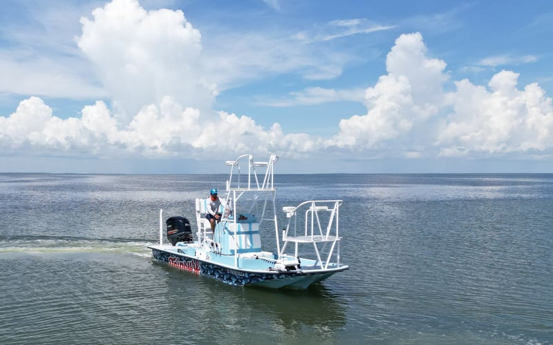 A small boat is floating on top of a large body of water.