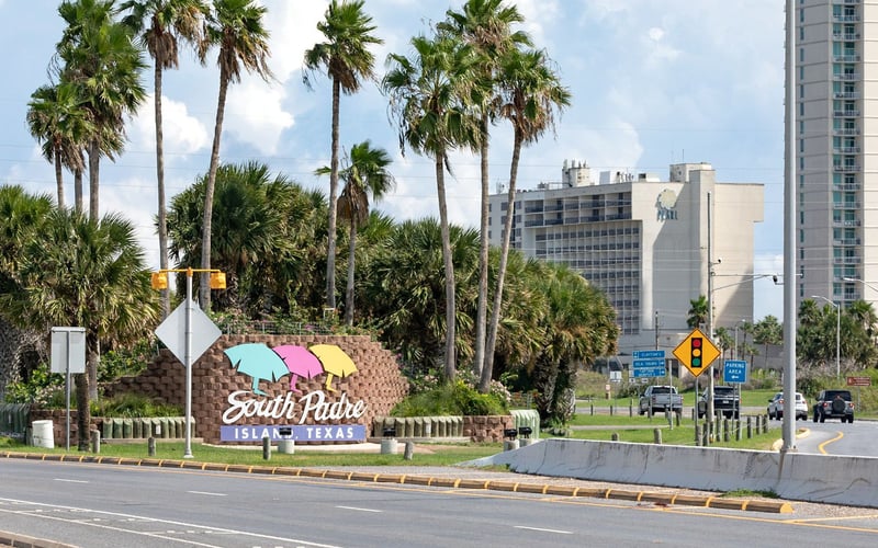 A sign on the side of a road that says south padre