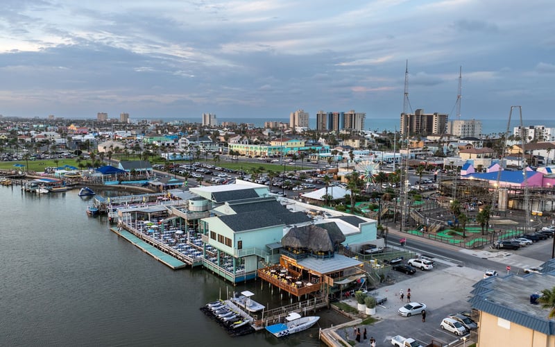 An aerial view of a city with boats docked in the water