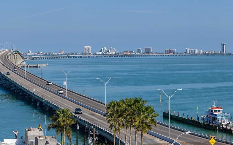 An aerial view of a bridge over a body of water.
