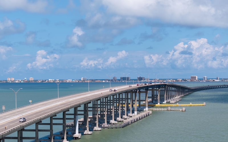 An aerial view of a bridge over a body of water.