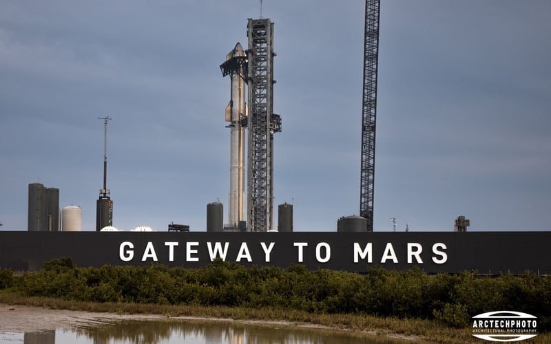 A gateway to mars sign with a rocket in the background